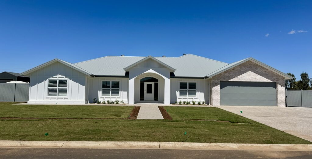 White single-storey home with a double garage on a wide, flat block in Dubbo, built by Robinson & Fuller Homes
