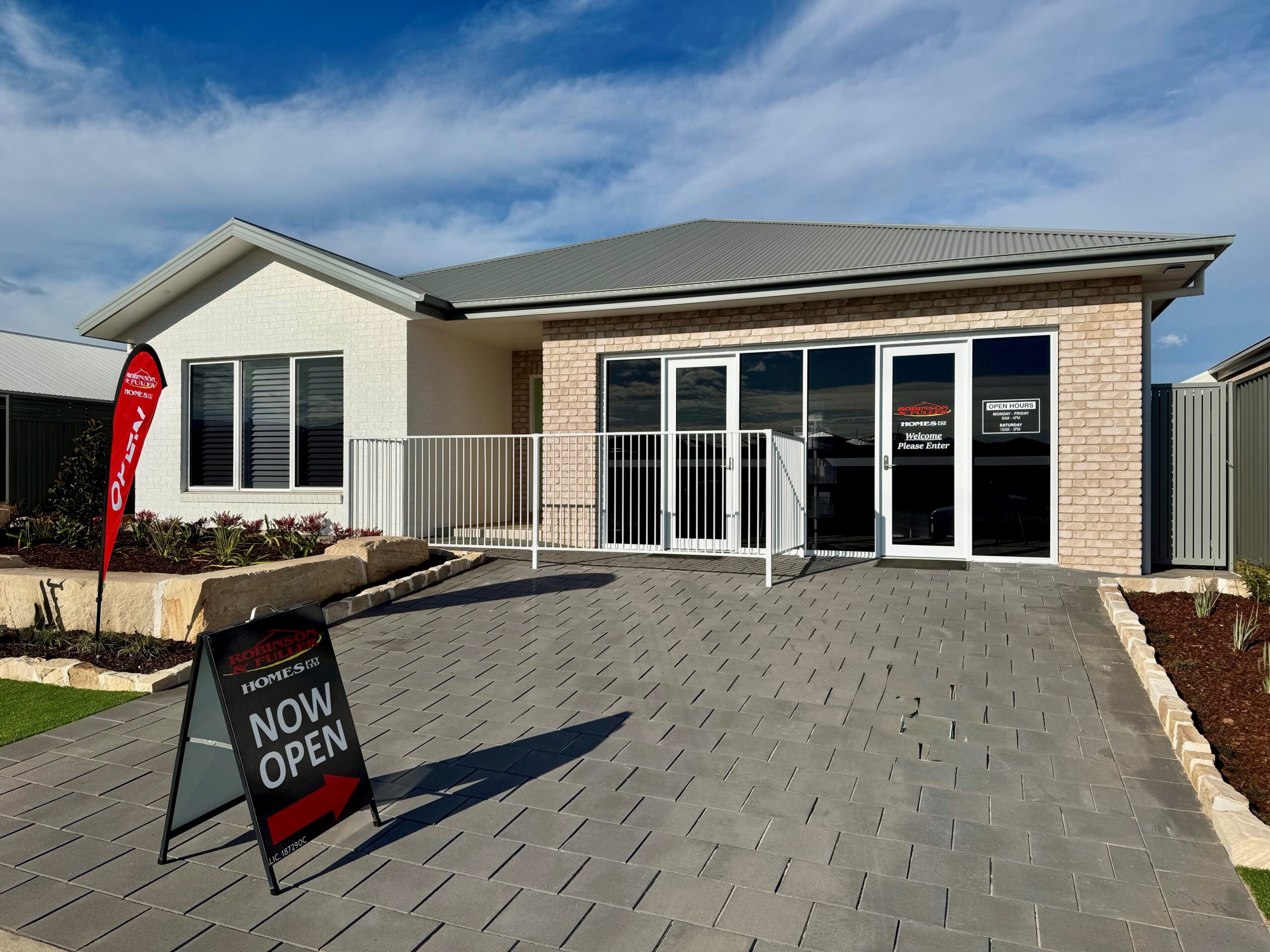 Robinson & Fuller Homes display home in Dubbo with a Now Open sign out the front